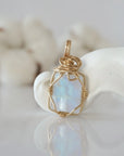 Back view of raw rainbow moonstone pendant in 14k gold filled, highlighting stone and wire detail. One of a kind June birthstone jewelry by Designs by Nature Gems.