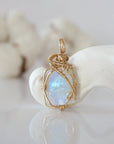Detailed front view of raw rainbow moonstone pendant in 14k gold filled. Unique wire wrapped June birthstone jewelry by Designs by Nature Gems.