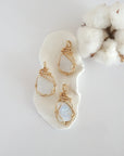 Three raw rainbow moonstone pendants in 14k gold filled, showing natural variation in size, shape, and color. Handcrafted June birthstone jewelry by Designs by Nature Gems.