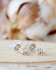 Back view of raw rainbow moonstone stud earrings showing 925 sterling silver posts and backs, minimalist June birthstone studs.