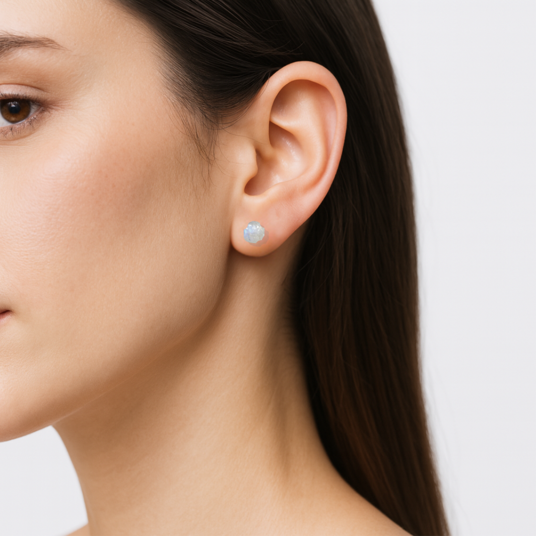 Model wearing raw rainbow moonstone stud earrings on 925 sterling silver posts, minimalist June birthstone earrings for everyday wear.