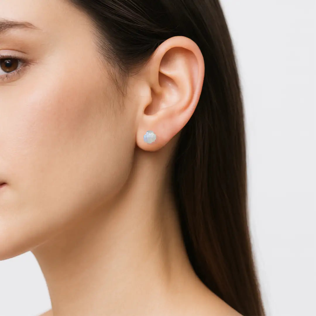 Model wearing raw rainbow moonstone stud earrings on 925 sterling silver posts, minimalist June birthstone earrings for everyday wear.