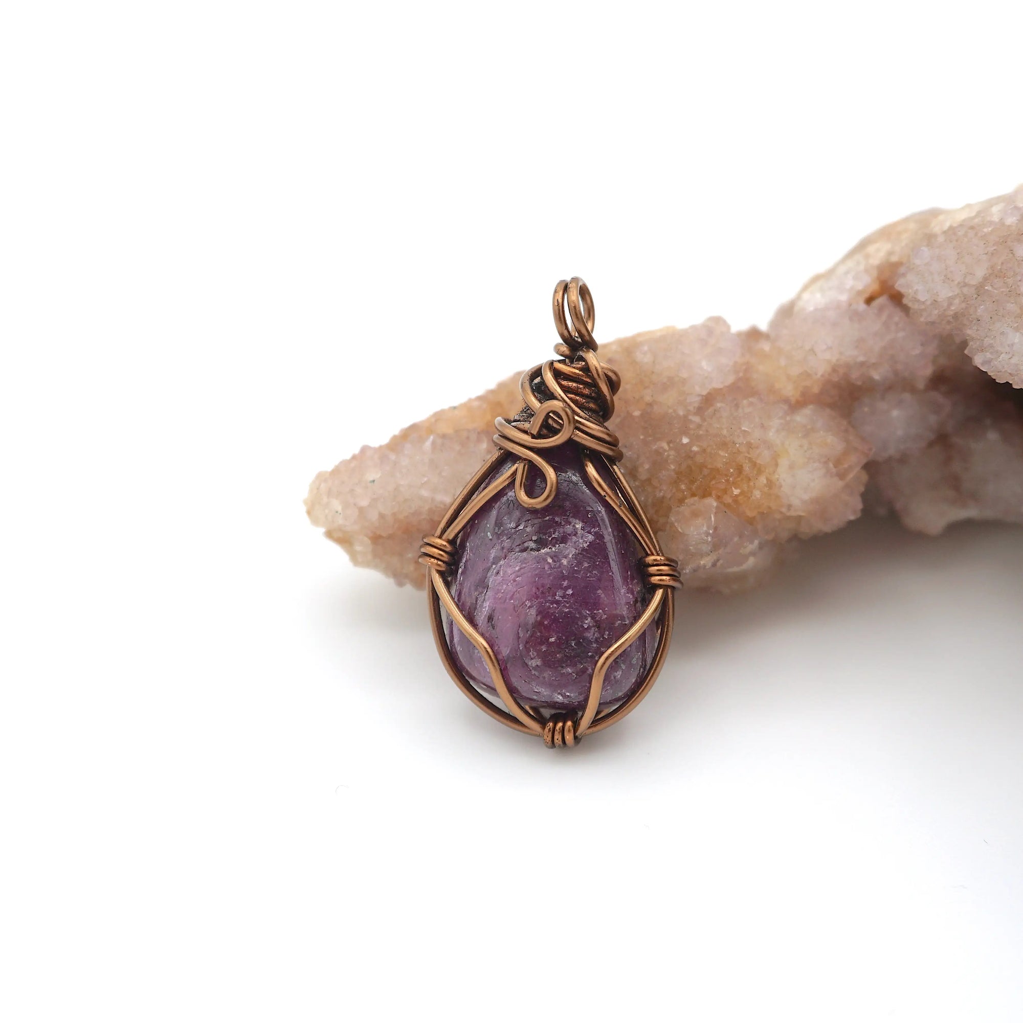 Back angle of raw ruby pendant displaying wire wrapping craftsmanship — handmade artisan crystal jewelry, nickel-free copper wire