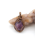 Back angle of raw ruby pendant displaying wire wrapping craftsmanship — handmade artisan crystal jewelry, nickel-free copper wire