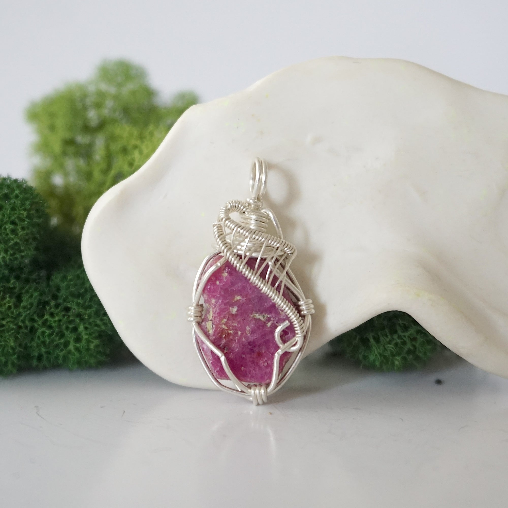 Front view of raw pink ruby pendant — natural unpolished ruby stone hand-wrapped in detailed 925 sterling silver wire, handcrafted artisan jewelry