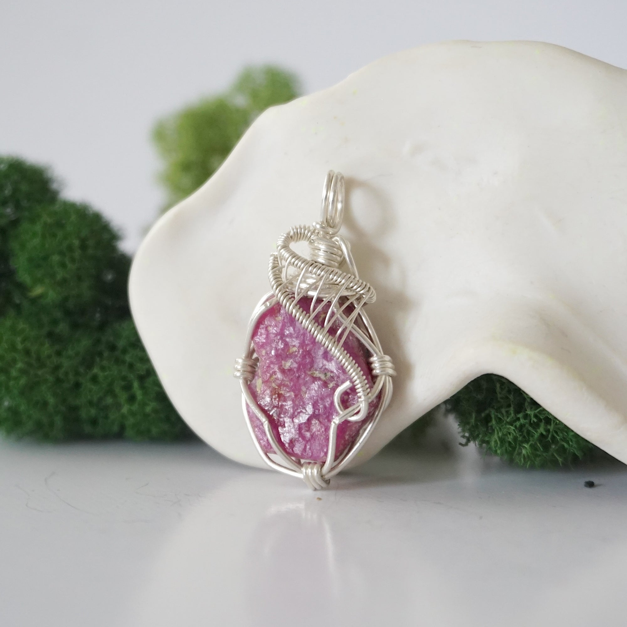 Left side detail of handmade raw ruby necklace — artisan wire wrapped 925 sterling silver pendant, natural ruby stone, ethically sourced crystal jewelry