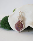 Left side view of raw ruby pendant highlighting silver wire wrap craftsmanship — natural crystal pendant, nickel-free copper wire