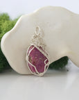 Right side detail of raw ruby crystal pendant — intricate 925 sterling silver wire weaving technique, handcrafted artisan wire wrapped jewelry, Designs by Nature Gems