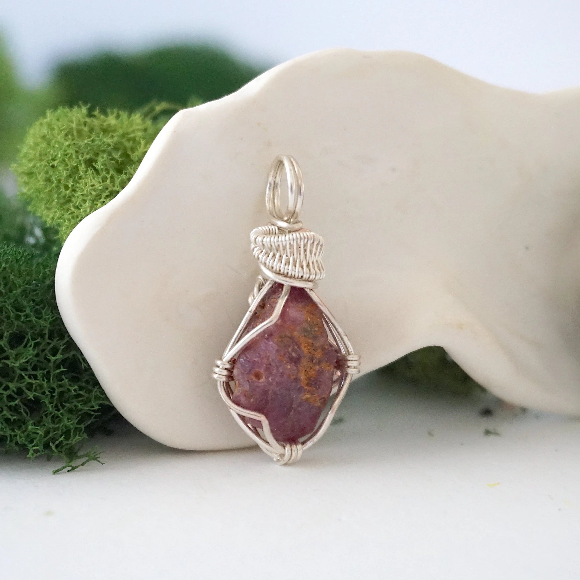 Right side view of handcrafted raw ruby pendant showing detailed artisan silver wire wrapping — handmade gemstone necklace for women