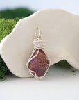 Right side view of handcrafted raw ruby pendant showing detailed artisan silver wire wrapping — handmade gemstone necklace for women