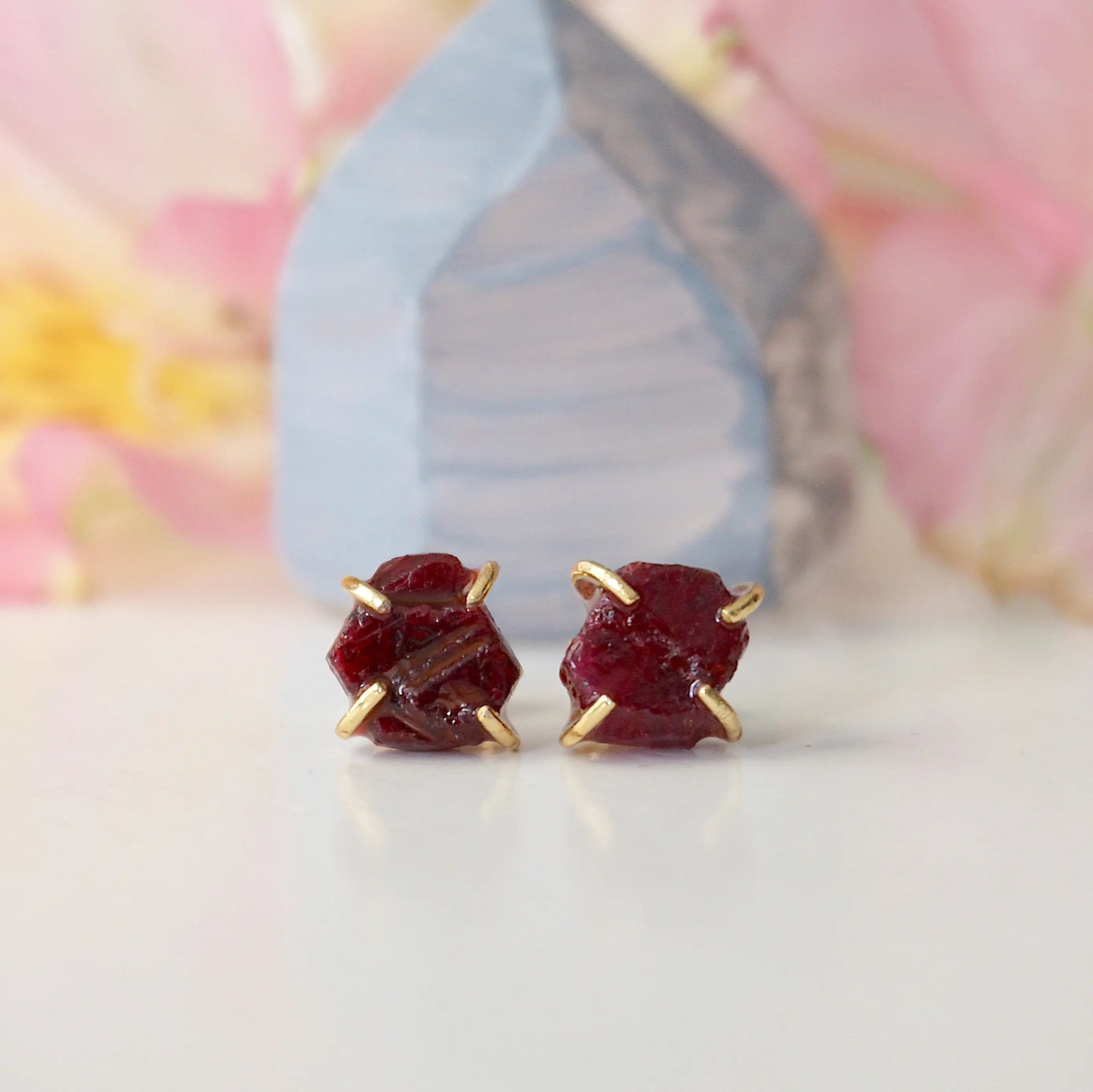 Front view of raw ruby prong stud earrings showing open claw 14k gold vermeil setting — minimalist natural crystal earrings for women