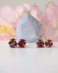 Two pairs of raw ruby prong stud earrings showing natural variation in stone shape, size, and colour — select your own pair, one of a kind by nature