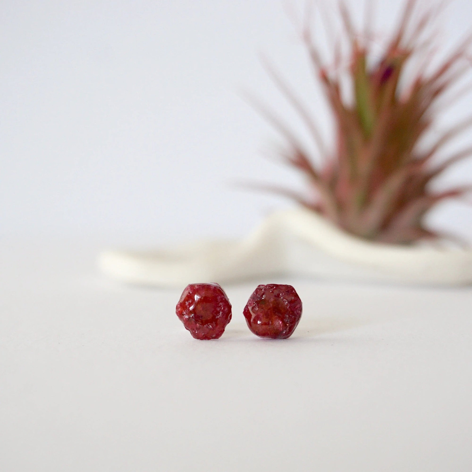Front view of raw ruby stud earrings showing natural rough stone surface — minimalist 925 sterling silver crystal stud earrings for women