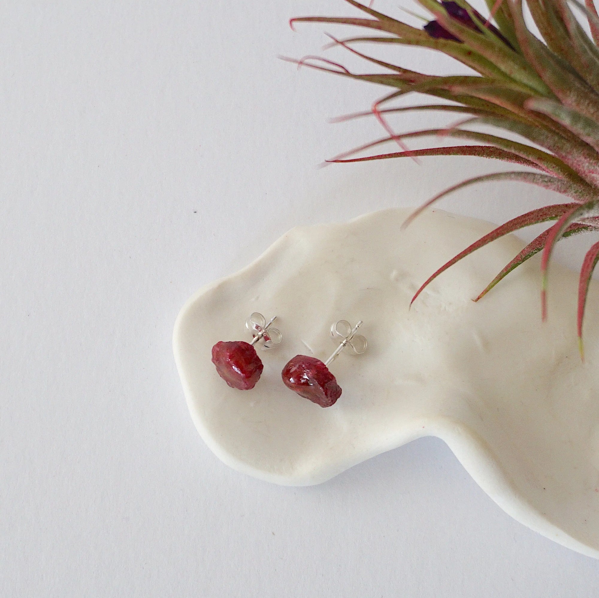 Top view of raw ruby stud earrings revealing natural stone surface and texture — 925 sterling silver natural crystal earrings