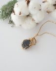 Raw sapphire necklace in 14k gold filled laying flat. Handcrafted September birthstone jewelry for women by Designs by Nature Gems.