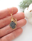 Raw sapphire necklace in 14k gold filled shown in hand for size reference. Artisan September birthstone pendant by Designs by Nature Gems.