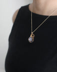 Raw sapphire necklace in 14k gold filled on a female model. Handcrafted September birthstone jewelry for women by Designs by Nature Gems.