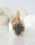 Back view of raw sapphire pendant in 14k gold filled, highlighting stone and wire detail. One of a kind September birthstone jewelry by Designs by Nature Gems.