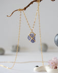 Back-angle view of raw sapphire pendant showing gold vermeil prong setting construction — 14k gold-filled chain, handcrafted by Designs by Nature Gems