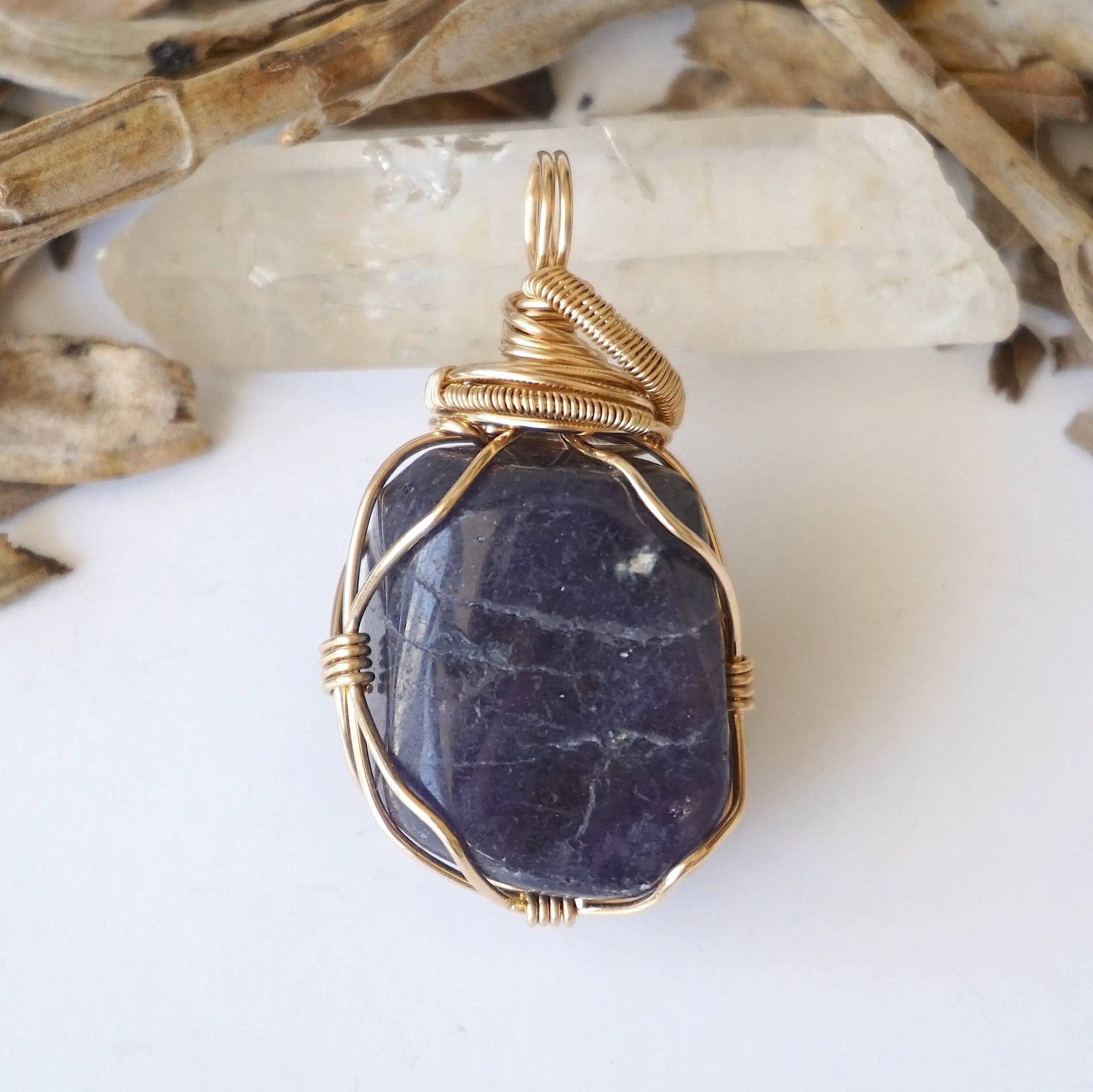 Back view of women's raw sapphire pendant showing the detail of 14k gold-filled wire-wrapping — one-of-a-kind handcrafted crystal jewelry