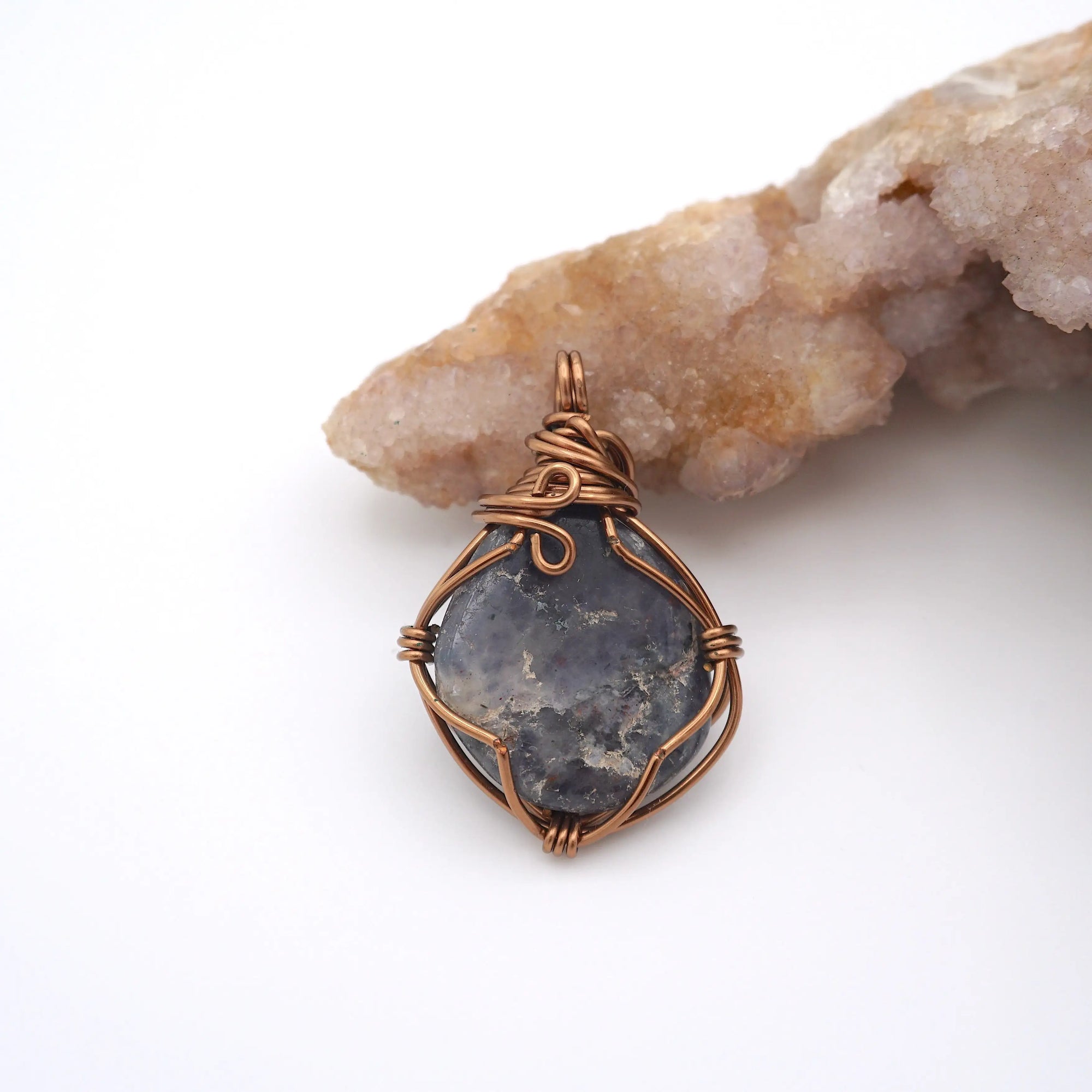Back view of raw sapphire pendant revealing the detail of antique bronze wire-wrapping craftsmanship — one-of-a-kind crystal necklace