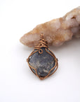 Back view of raw sapphire pendant revealing the detail of antique bronze wire-wrapping craftsmanship — one-of-a-kind crystal necklace