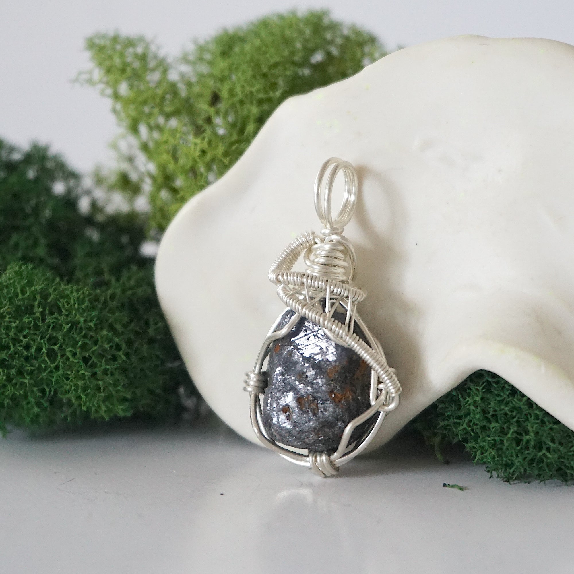 Left side detail of handmade raw sapphire necklace — artisan wire wrapped 925 sterling silver pendant, natural sapphire stone, ethically sourced crystal jewelry