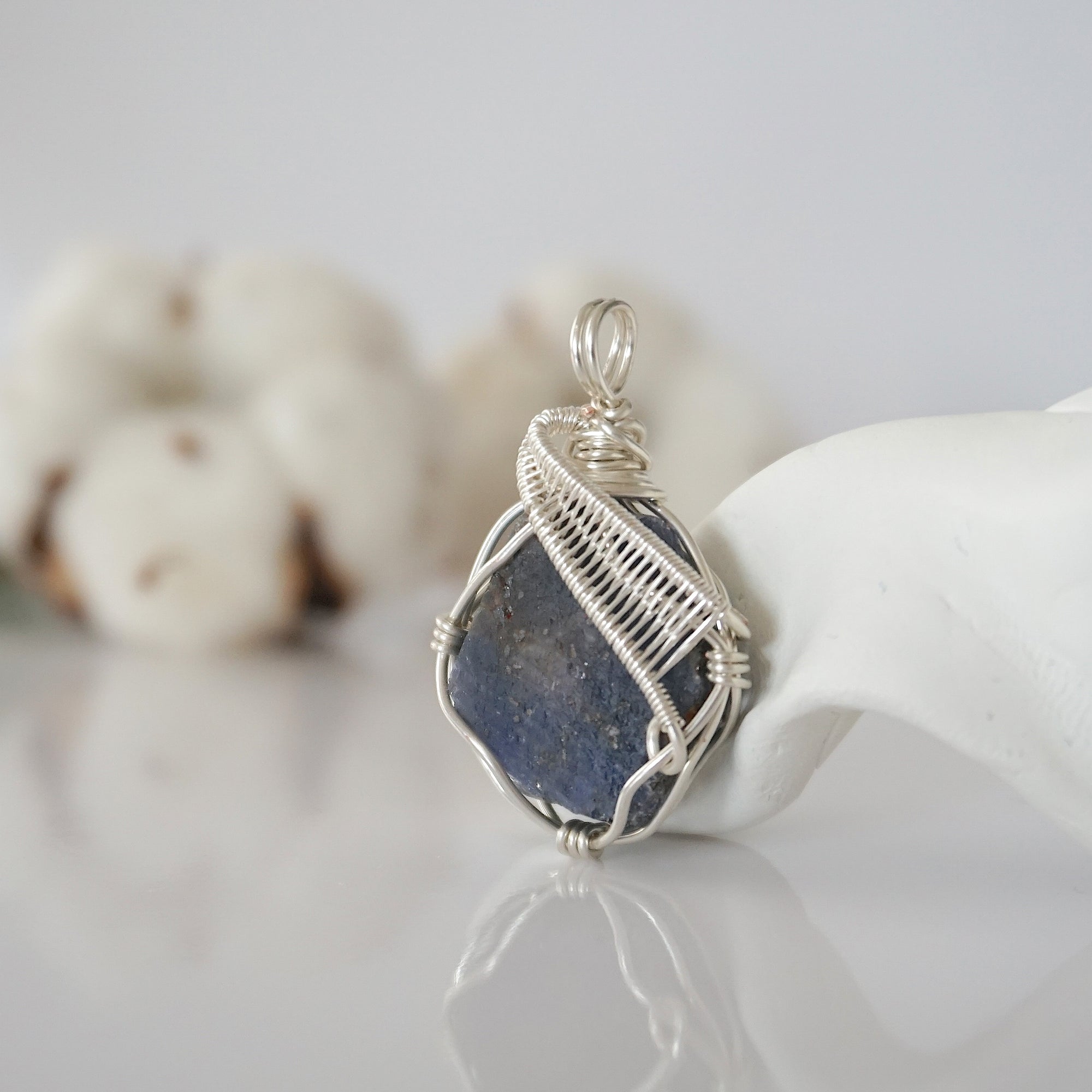 Left side detail of raw sapphire crystal pendant — intricate silver finish wire weaving technique, nickel-free wire, handcrafted artisan wire wrapped jewelry, Designs by Nature Gems