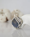 Left side detail of raw sapphire crystal pendant — intricate silver finish wire weaving technique, nickel-free wire, handcrafted artisan wire wrapped jewelry, Designs by Nature Gems