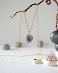 Side-angle detail of raw sapphire pendant in a minimalist gold vermeil prong setting — delicate handcrafted crystal necklace by Designs by Nature Gems