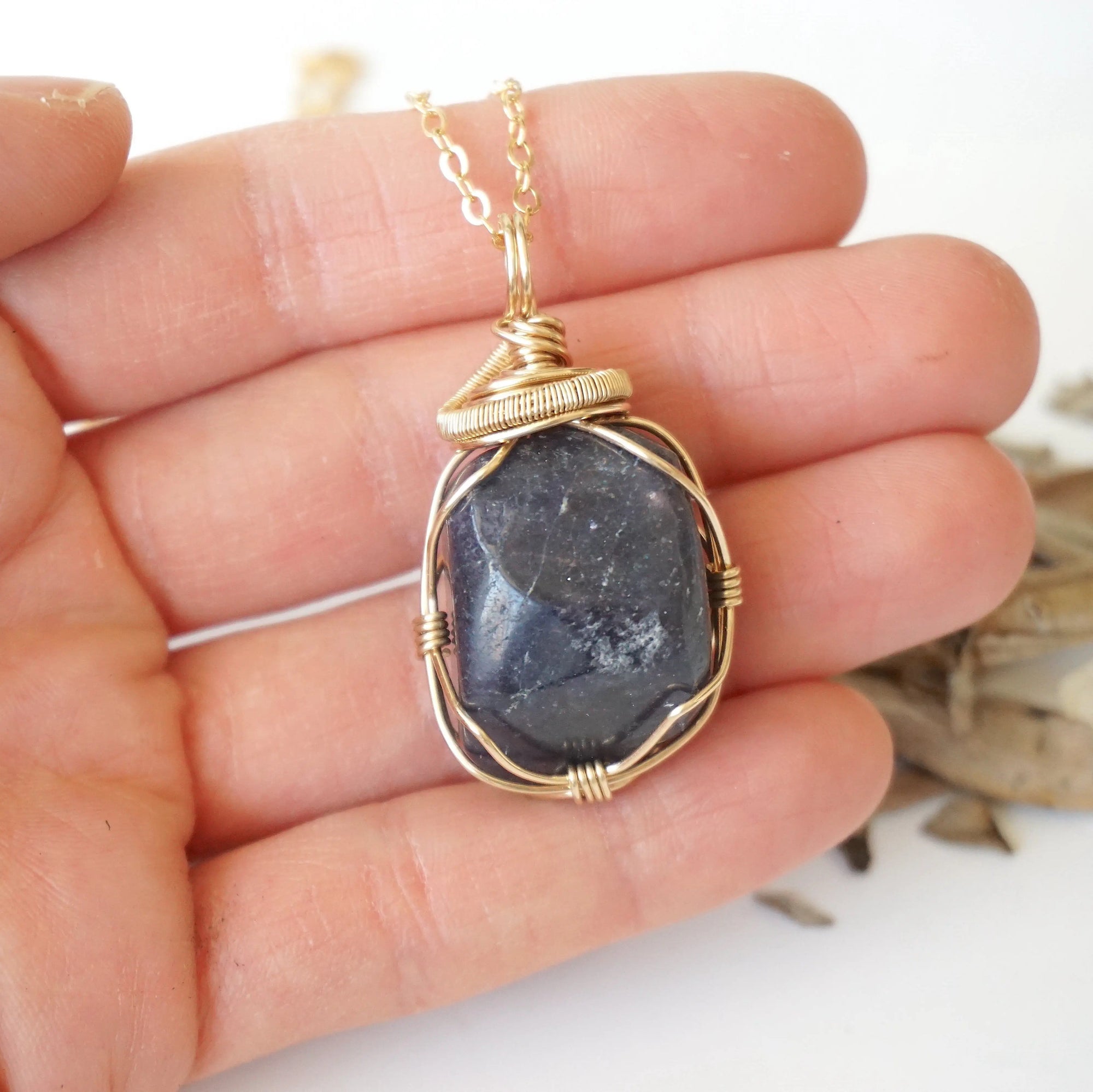 Raw sapphire pendant held in hand to show size — 14k gold-filled wire wrap, women's handcrafted crystal necklace by Designs by Nature Gems