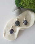 Three different raw sapphire pendants displayed for variation reference