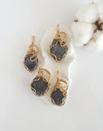Four raw sapphire pendants in 14k gold filled, showing natural variation in size, shape, and color. Handcrafted September birthstone jewelry by Designs by Nature Gems.