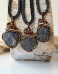 Three raw sapphire pendants showing natural variation in size, shape, and depth of colour — each men's wire-wrapped necklace is individually handcrafted and one of a kind