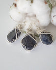 Three raw sapphire pendants showing natural variation in size, shape, and depth of colour — each women's 925 sterling silver wire-wrapped necklace is individually handcrafted and one of a kind