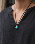 Model wearing raw turquoise necklace on leather