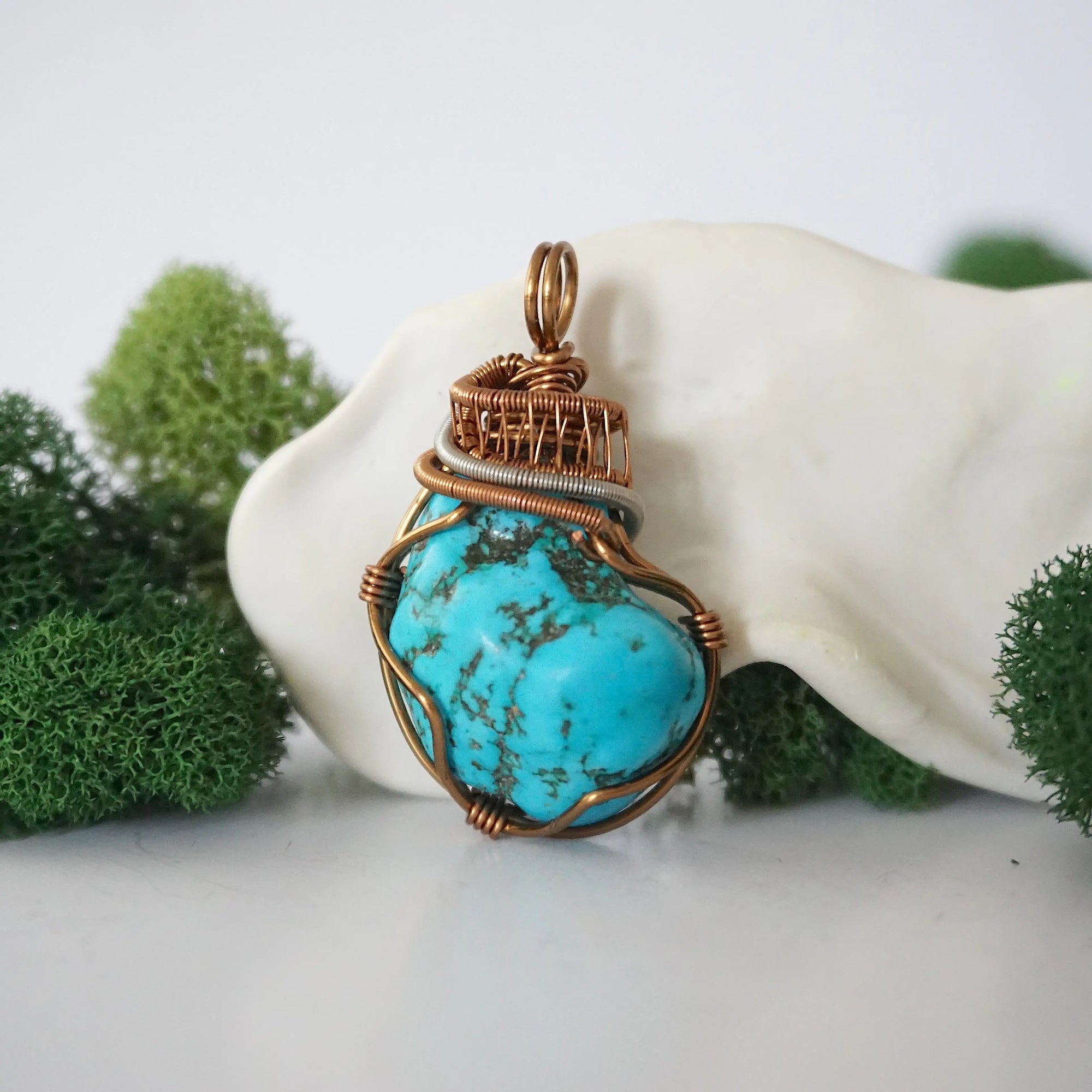 Front view of raw turquoise pendant showing detailed antique bronze copper wire wrapping, handmade artisan jewelry