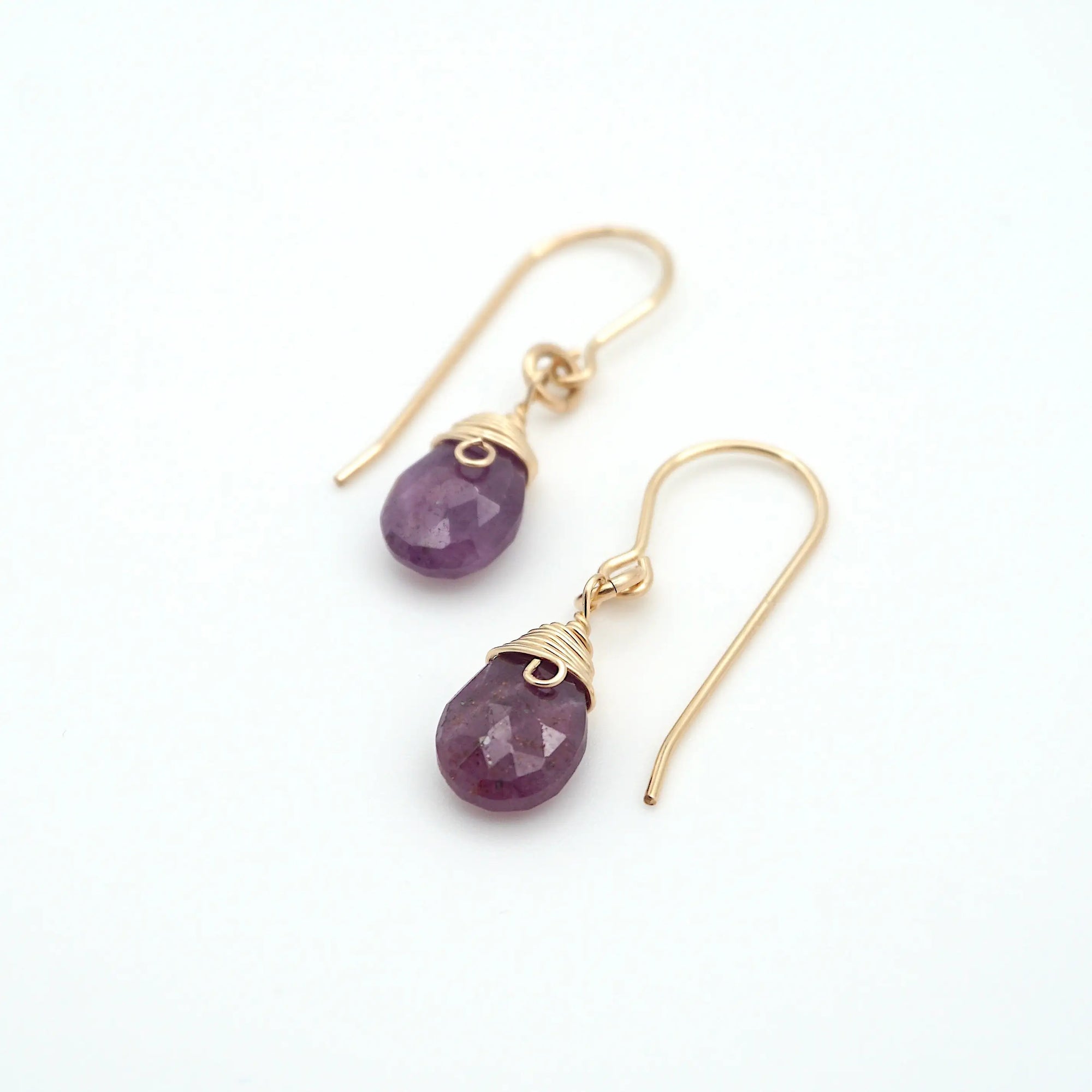 Angled look at ruby drop earrings, artisan wire wrapping in 14k gold filled, July birthstone