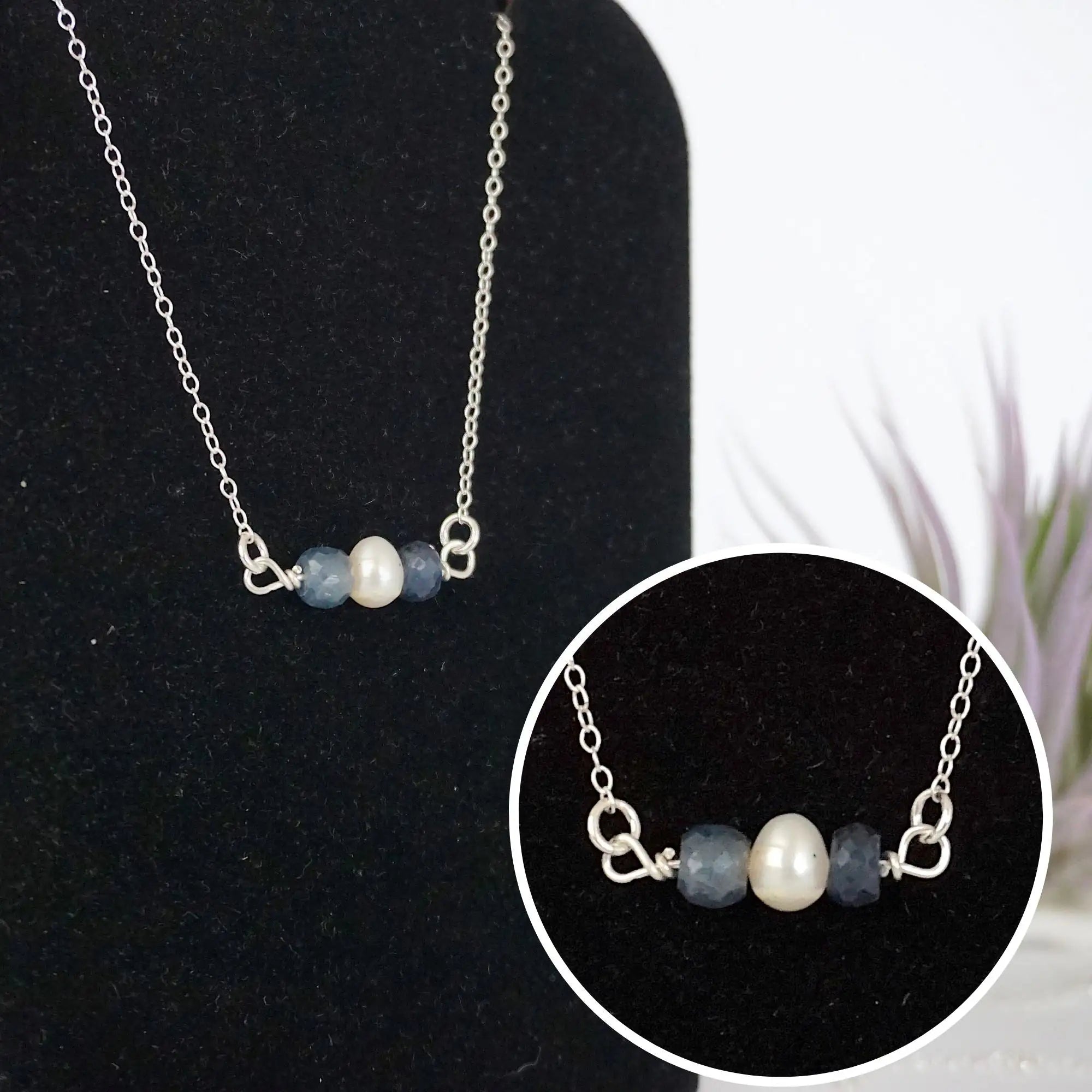 Close-up of raw sapphire stones and freshwater pearl bar on 925 sterling silver necklace