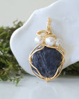 Detailed front angle of sapphire and freshwater pearl pendant, gold wire wrapped, handcrafted gemstone jewelry