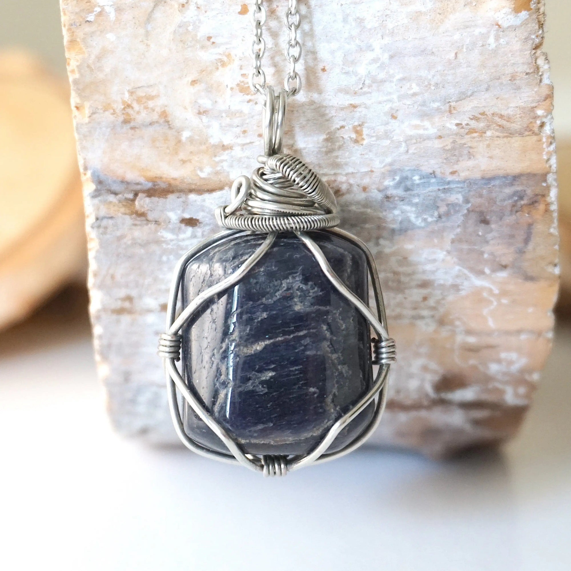 Back view of natural sapphire pendant showing the detail of dark silver wire-wrapping — white gold chain, one-of-a-kind handcrafted crystal jewelry