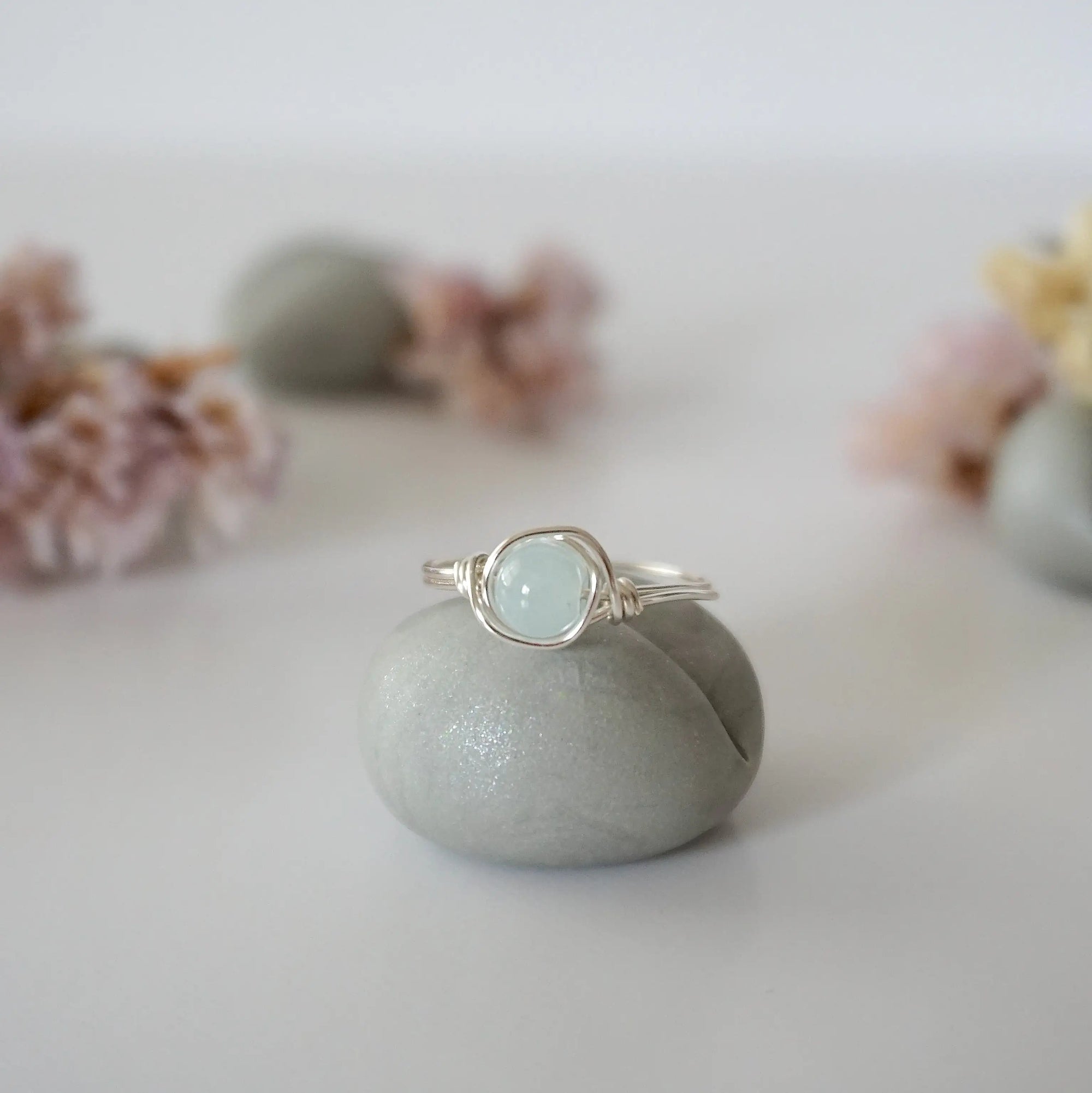 Detailed front view of minimalist silver aquamarine ring, natural 6mm aquamarine bead