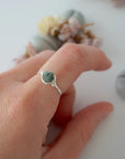 Minimalist silver emerald ring on a model's hand by Designs by Nature Gems, handcrafted May birthstone ring for women.