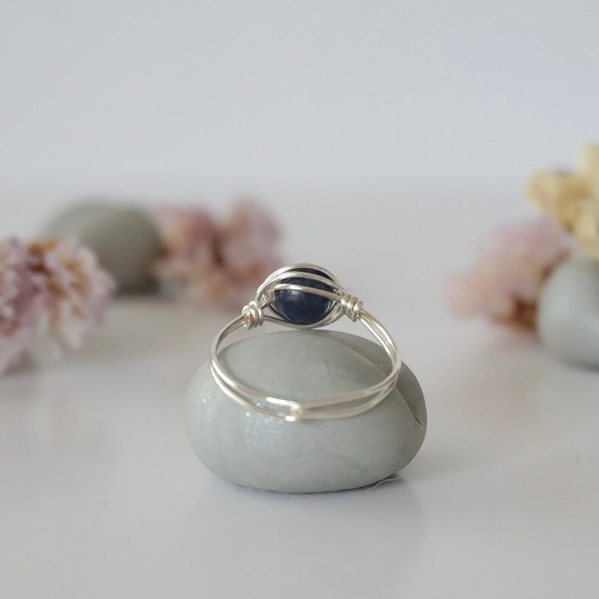 Back-angle view of silver sapphire ring revealing the handcrafted minimalist wire-wrapped band and artisan finish