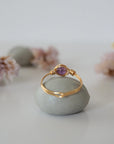 Back view of gold amethyst ring showing minimalist wire wrapped band and polished 6mm amethyst bead setting