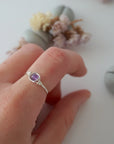 Simple amethyst birthstone ring in silver finish on model hand, minimalist 6mm amethyst bead wire wrap