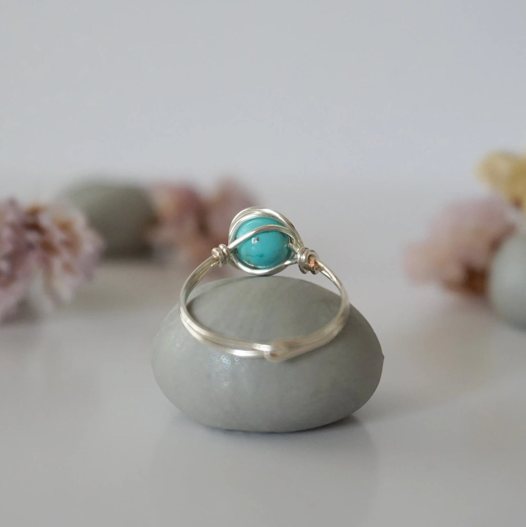Back view of simple turquoise ring in silver plated copper showing handmade wire wrapping detail and craftsmanship quality