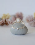 Back view of a minimalist pearl wire wrapped ring crafted in sterling silver