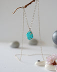 Side angle view of sterling silver turquoise necklace showing stone depth and profile