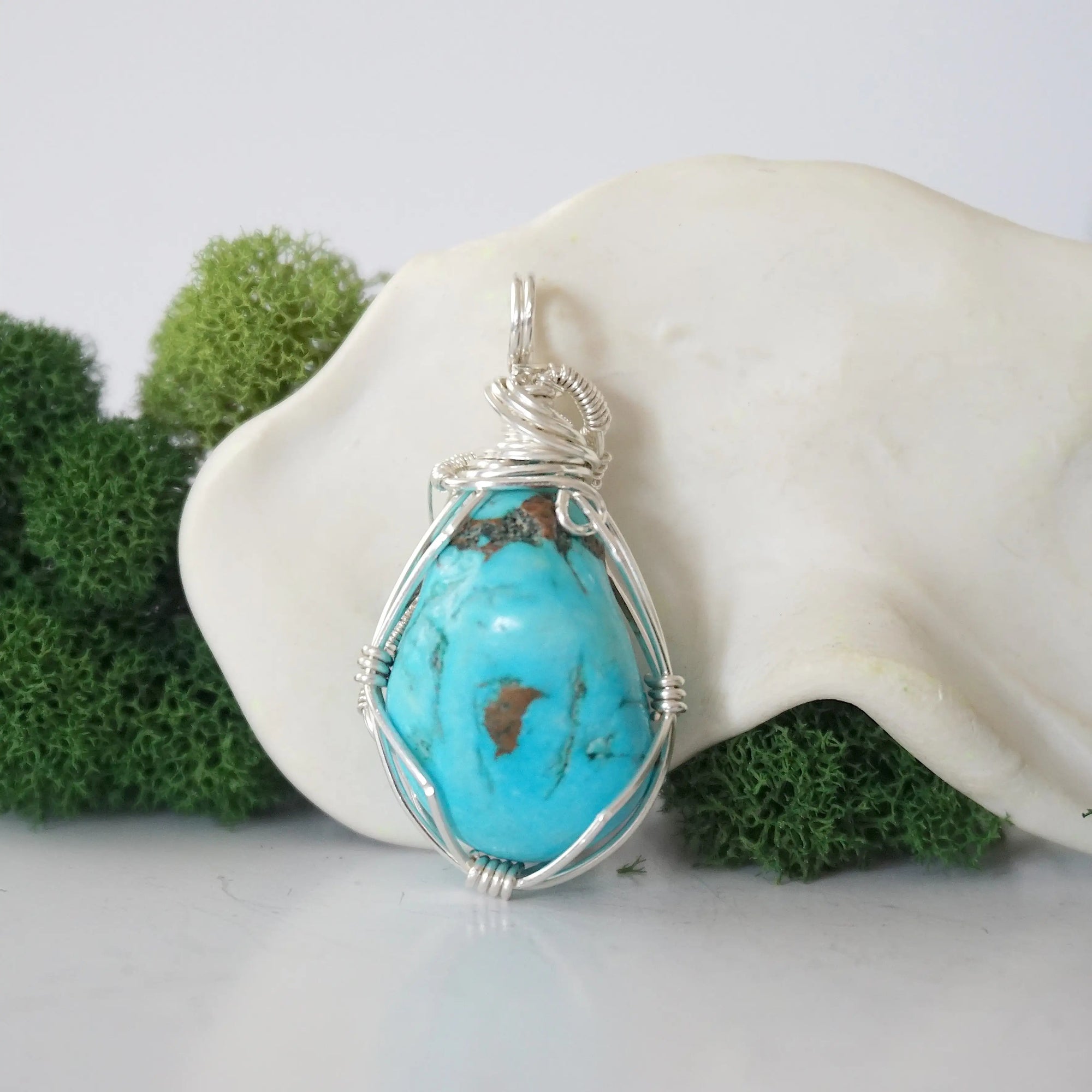 Back view of 925 silver wire wrapped raw turquoise pendant showing detailed craftsmanship and artisan technique